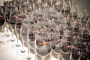 Stemware of red wine on a white table. Banquet. Toned