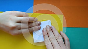 Step 6. female hands make paper boat. Step-by-step instructions on how to make origami paper ship.