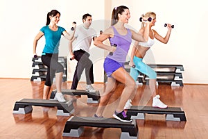 Step aerobics with dumbbells