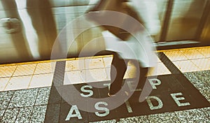 Step aside sign in New York subway station