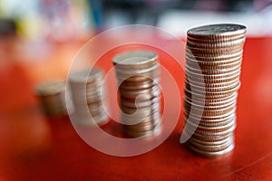 Step of coins stacks, money, saving and investment or family planning concept, motion blured background.