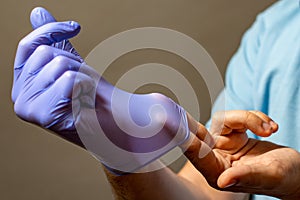 Step of hand throwing away blue disposable gloves medical, Isolated on white background. Infection control concept photo