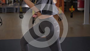 Step platforms. Girl in sports grey leggings and top doing exercises for aerobics. The concept of tightening in the gym