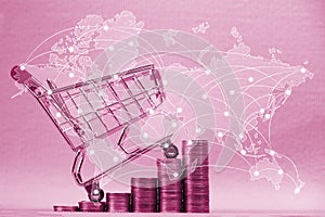 Step of stacks of coins and shopping cart or supermarket trolley and world map,.global network , business finance shopping concept