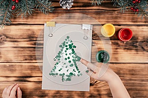 Step-by-step Greeting card Christmas tree with children`s fingerprints tutorial. Step 6: Make prints along outline