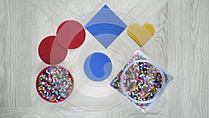 Step-by-step instructions for thermo mosaic: step 1.Set of forms with pins,container with colorful beads.Family crafts