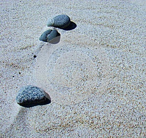 Step by step pebble walk on the beach