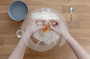 A step-by-step process for preparing dumplings. View from above. Men`s hands gradually mix the ingredients: flour, egg, water, oi