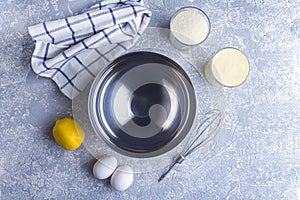 Step by step recipe. Cooking lemon pie or semolina cake. Step 1 Ingredients: empty metal bowl, semolina, sugar, eggs, lemon, whisk