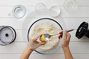 Step by step recipe galette or pie with nectarines. Female hands squeezing lemon into spoon for dough.