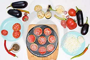 Step-by-step recipe for homemade vegan pizza with eggplant for a bite, tomatoes, peppers, mozzarella . hands of a woman preparing