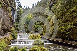 Step waterfall surrounded by hilly forests