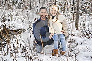 stepfather and daughter on forest in winter season