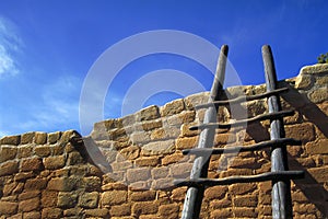 Stepladder against brick wall photo