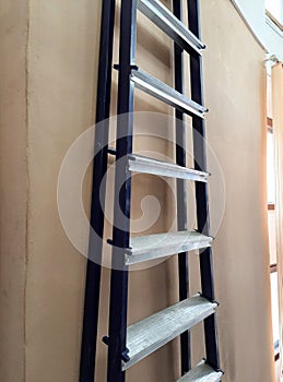 The stepladder is hanging on the wall in the room