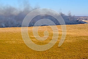 Steppe fire. Burning dry grass, fire smoke photo