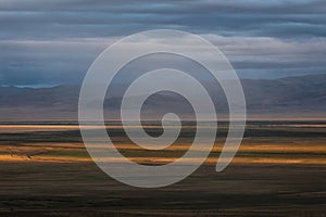 Steppe sunset mountains rain sunlight clouds