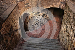 Stepped descent into the dungeon of the medieval castle photo