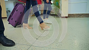 Stepping feet,A woman with a large baggage in her hand is dragging her things around the hotel lobby, the lady is