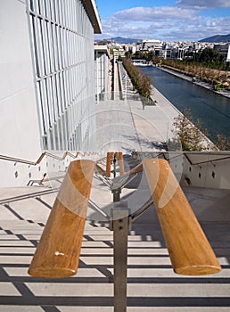 Steps down, crossed by shadows, on a sunny day at the Stavros Niarchos Cultural Center in Athens, Greece