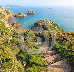 Steps down to the ocean along the beautiful coastline of Jersey Channel Islands