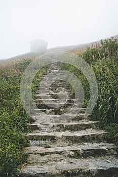 Steps leading to house in fog on Wugong Mountain in Jiangxi, China