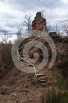 Steps leading up to small German castle ruin on cloudy day