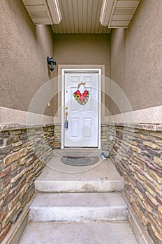 Steps on a narrow entryway leading to front door