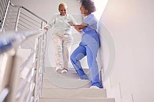 Steps, nurse and help elderly woman, holding hands and assistance in home. Caregiver, stairs and senior African patient