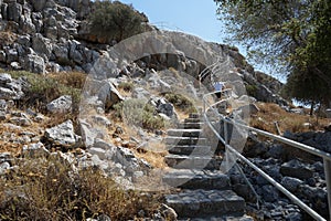 Steps with railings lead to the Church of Prophet Elias. Pefkos or Pefki, Rhodes Island, Greece