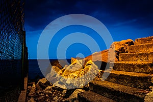 Steps On Rocky Shoreline At Night