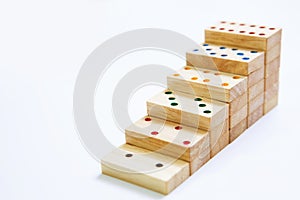 Steps or stair of wooden domino on white background and copy sp