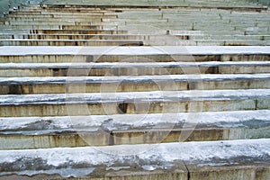 Steps of stairs covered by snow in a park in winter closeup