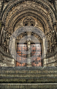 Steps to a set of gothic church doors.