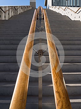 Steps up, crossed by shadows, on a sunny day at the Stavros Niarchos Cultural Center in Athens, Greece