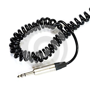 Stereo audio headphone jack with cable on white background.