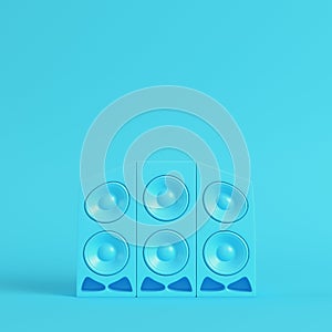 Stereo cartoon-styled speakers on bright blue background in past