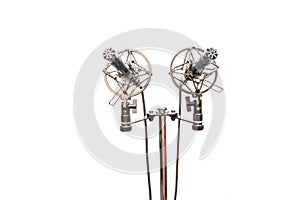 Stereo condenser microphones with cables, shockmounts and stand isolated on white