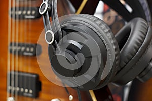 Stereo headphones with guitar,home folk song recording concept , vintage style. Music entertain headphone and acoustic guitar isol