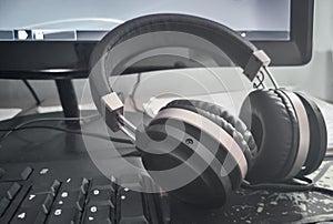 Stereo headphones on the keyboard of a computer