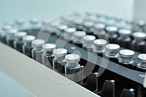 Sterile capsules for injection. Bottles on the bottling line of the pharmaceutical plant. Machine after checking sterile