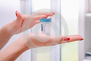A sterile container for collecting biomaterials disposable 100 ml with a blue lid
