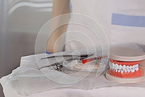 Sterile cotton napkins and stomatological tools on a table. Closeup photo