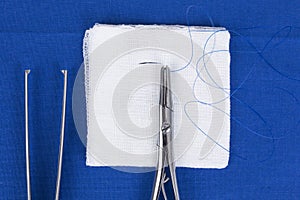 Sterile needle and needle holder on wound dressing