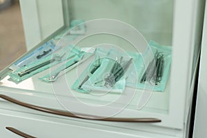 Sterile new medical dental instruments lie in the doctor`s offic