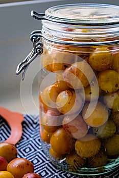 Sterilized mirabelle plums, homemade fruits in syrup for the winter, preserves nutrients