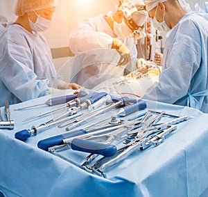 Sterilized surgical instruments and tools on the blue table.