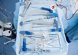 Sterilized surgical instruments and tools on the blue table.