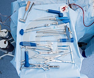 Sterilized surgical instruments and tools on the blue table.