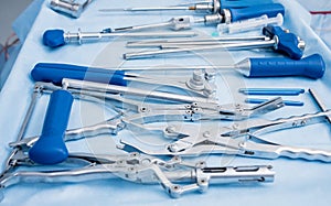 Sterilized surgical instruments and tools on the blue table.